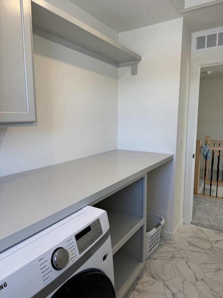Laundry room built-in counter and open storage